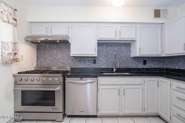 kitchen featuring white cabinetry, appliances with stainless steel finishes, sink, and tasteful backsplash