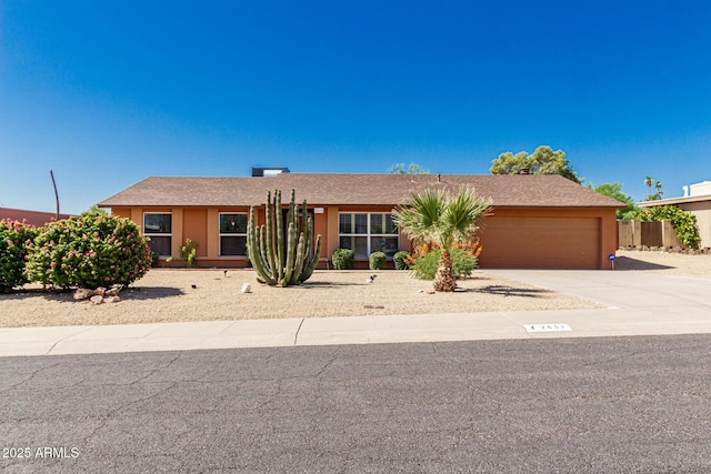 2437 E N Ln, Phoenix, AZ 85028 - view of front facade with an attached garage, concrete driveway, and stucco siding