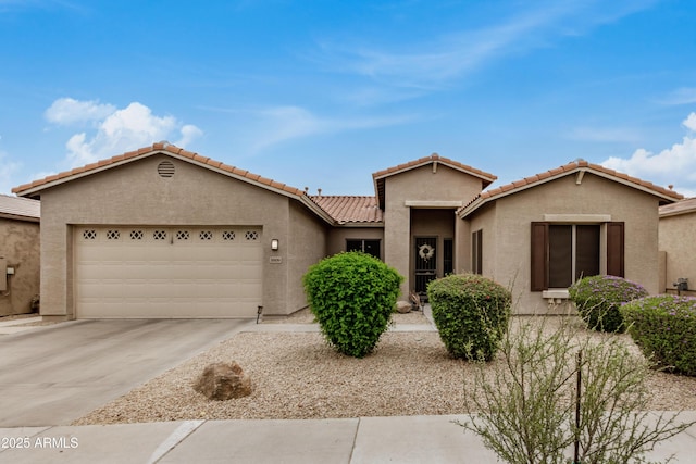 8809 S 21st St, Phoenix, AZ 85042 - view of front of house featuring a garage, stucco siding, concrete driveway, and a tile roof