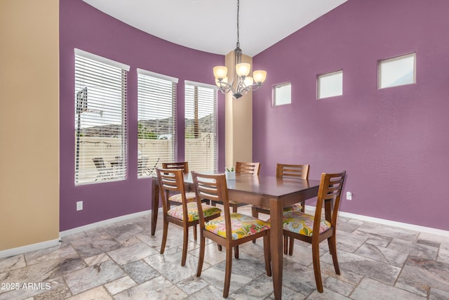 8809 S 21st St, Phoenix, AZ 85042 - dining space featuring stone tile flooring, baseboards, and a notable chandelier