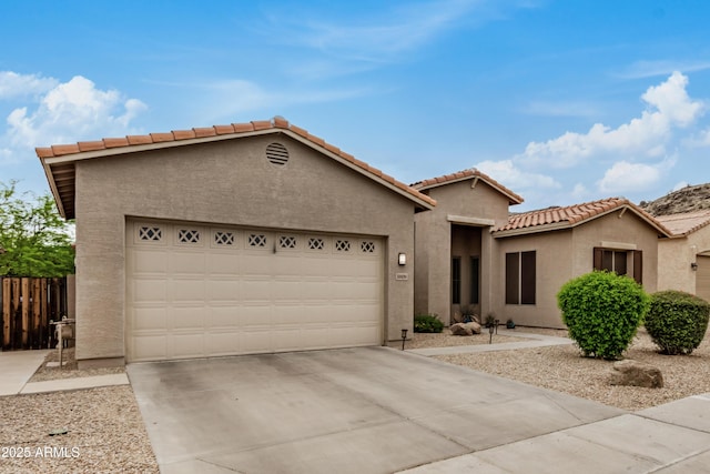 8809 S 21st St, Phoenix, AZ 85042 - view of front of house featuring a garage, driveway, stucco siding, and a tiled roof