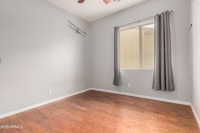 8809 S 21st St, Phoenix, AZ 85042 - spare room with ceiling fan, baseboards, and hardwood / wood-style flooring