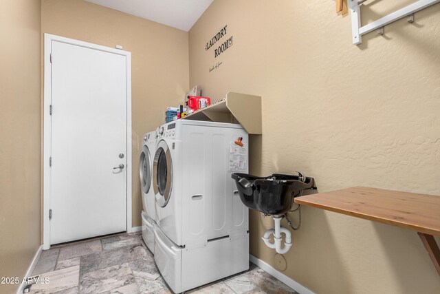 8809 S 21st St, Phoenix, AZ 85042 - clothes washing area featuring stone finish flooring, washer and dryer, laundry area, and baseboards