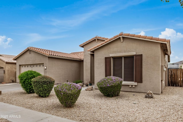 8809 S 21st St, Phoenix, AZ 85042 - view of front of property featuring a tile roof, an attached garage, fence, and stucco siding