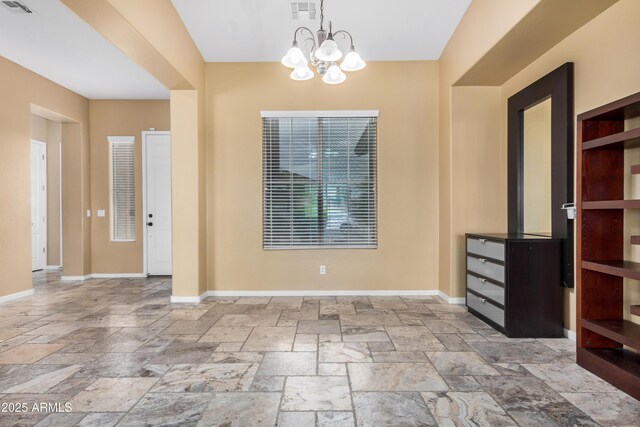 8809 S 21st St, Phoenix, AZ 85042 - unfurnished dining area featuring stone tile floors, baseboards, and visible vents