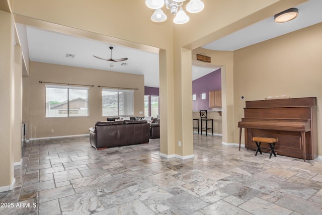 8809 S 21st St, Phoenix, AZ 85042 - living room featuring stone tile floors, baseboards, and plenty of natural light