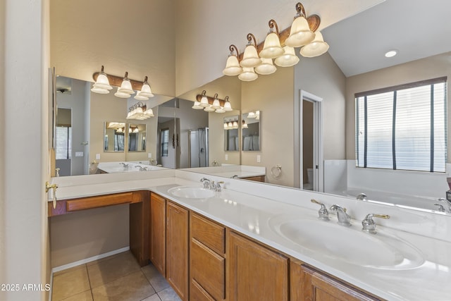 full bathroom with double vanity, a sink, toilet, and tile patterned floors