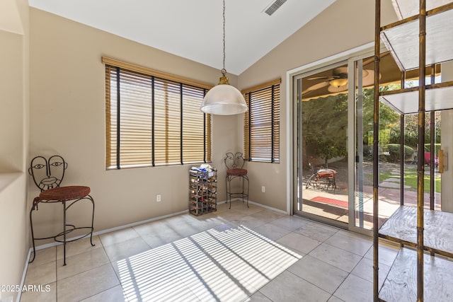 unfurnished dining area featuring lofted ceiling, baseboards, visible vents, and tile patterned floors