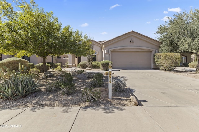 view of front of property with driveway, an attached garage, a tiled roof, and stucco siding