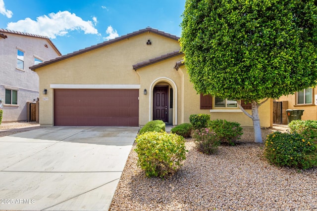 16771 W Adams St, Goodyear, AZ 85338 - mediterranean / spanish home featuring concrete driveway, stucco siding, and an attached garage