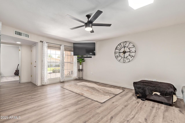 sitting room featuring a ceiling fan, wood finished floors, baseboards, and visible vents