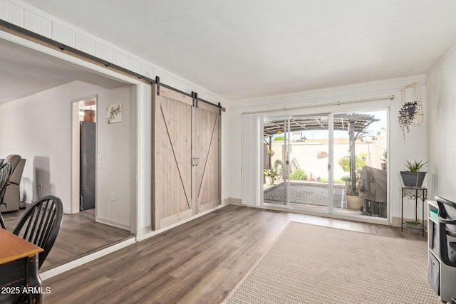 office area with a barn door and wood finished floors