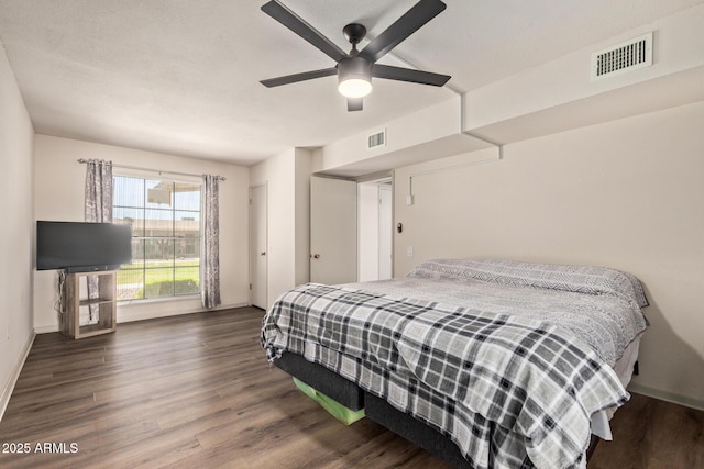 bedroom with wood finished floors, baseboards, and visible vents