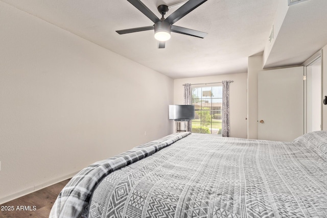 bedroom with baseboards, ceiling fan, and wood finished floors