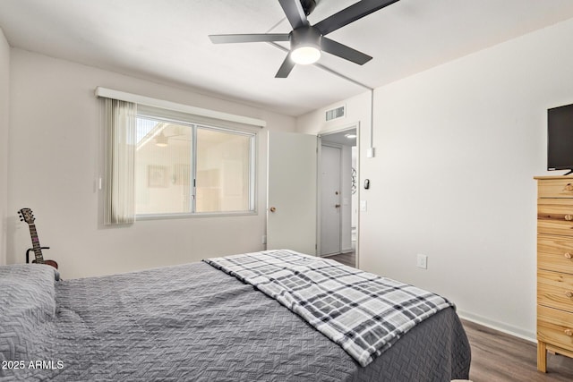 bedroom featuring visible vents, wood finished floors, and ceiling fan