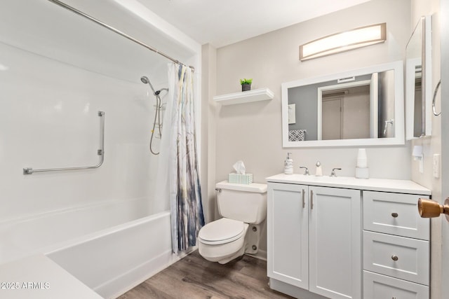 full bath featuring toilet, wood finished floors, vanity, and shower / bathtub combination with curtain