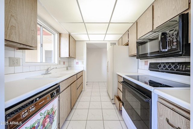 kitchen with light countertops, dishwasher, black microwave, and electric stove