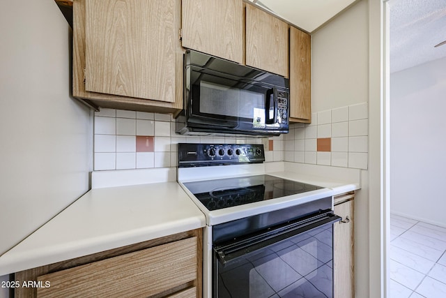 kitchen with range with electric cooktop, black microwave, tasteful backsplash, and light countertops