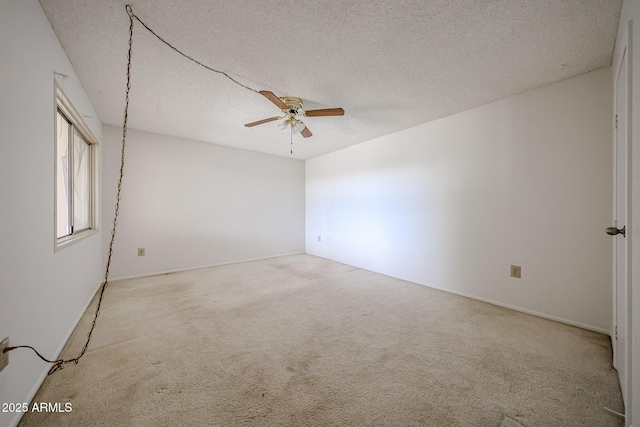spare room featuring a ceiling fan, a textured ceiling, and carpet