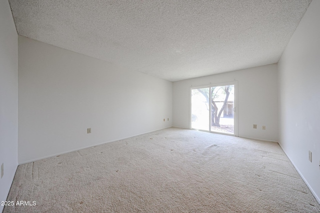 empty room featuring carpet flooring and a textured ceiling