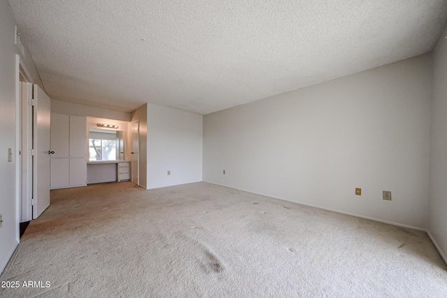 interior space featuring carpet flooring and a textured ceiling