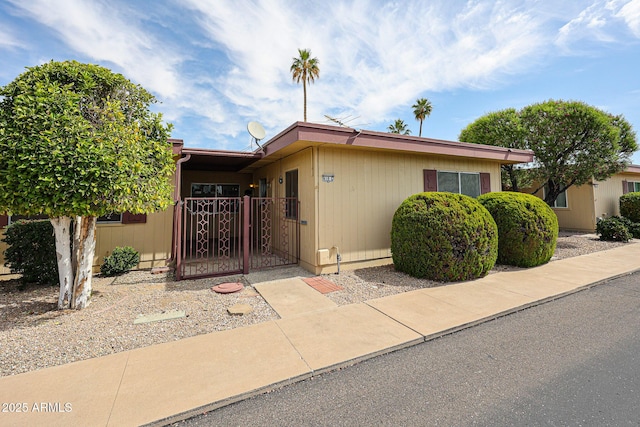 view of front of home with fence and a gate