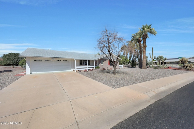 ranch-style home featuring an attached garage and concrete driveway