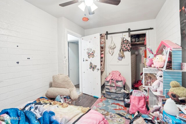2223 E Roosevelt St, Phoenix, AZ 85006 - bedroom with a barn door, a ceiling fan, and wood finished floors