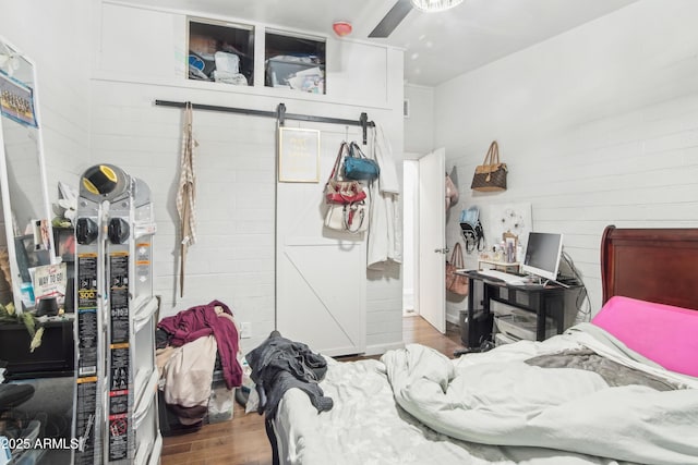2223 E Roosevelt St, Phoenix, AZ 85006 - bedroom with ceiling fan, a barn door, and wood finished floors