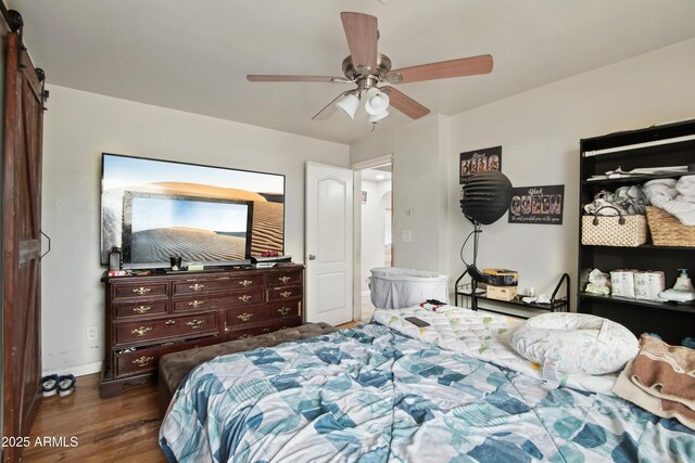 2223 E Roosevelt St, Phoenix, AZ 85006 - bedroom with baseboards, ceiling fan, a barn door, and dark wood-type flooring