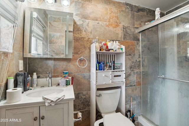 2223 E Roosevelt St, Phoenix, AZ 85006 - full bath featuring a stall shower, tile walls, vanity, and toilet