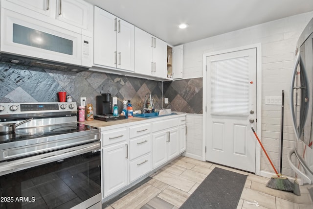 2223 E Roosevelt St, Phoenix, AZ 85006 - kitchen featuring a sink, open shelves, light countertops, white cabinets, and appliances with stainless steel finishes