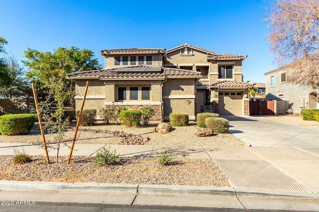 mediterranean / spanish home with a garage