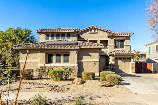 mediterranean / spanish-style home with a garage