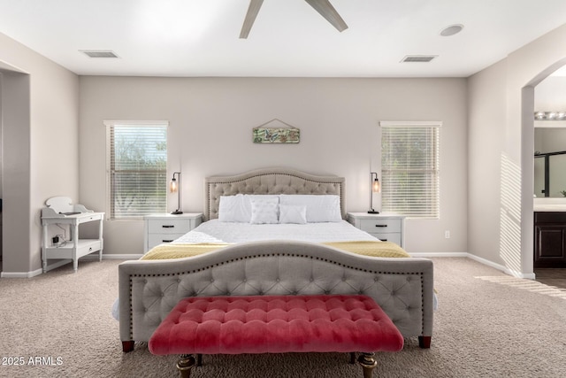 bedroom featuring ensuite bathroom, ceiling fan, and carpet