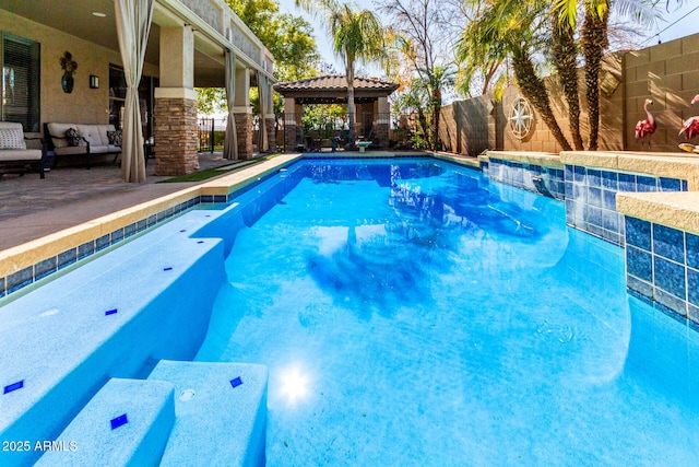 view of swimming pool with a gazebo and an outdoor hangout area