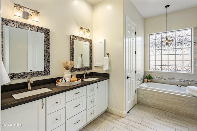 654 E County Down Dr, Chandler, AZ 85249 - bathroom featuring double vanity, a bath, and baseboards