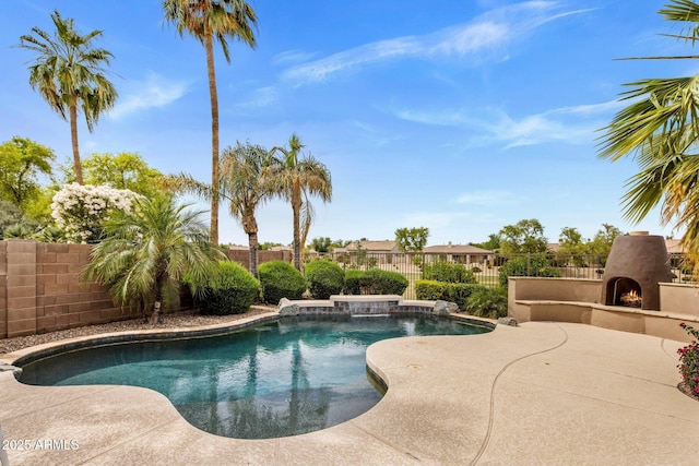 654 E County Down Dr, Chandler, AZ 85249 - view of pool with a warm lit fireplace, a fenced backyard, and a patio area