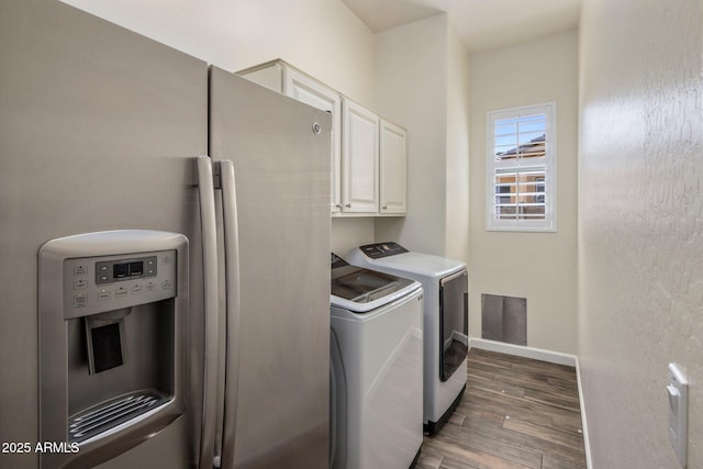 654 E County Down Dr, Chandler, AZ 85249 - washroom with cabinet space, washing machine and clothes dryer, wood finished floors, and baseboards