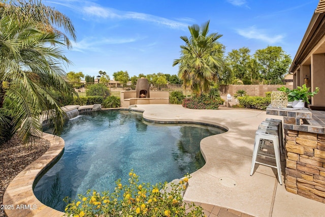 654 E County Down Dr, Chandler, AZ 85249 - view of swimming pool featuring a patio, a fenced backyard, and an outdoor kitchen