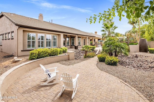 654 E County Down Dr, Chandler, AZ 85249 - rear view of house featuring a patio, stucco siding, and a chimney