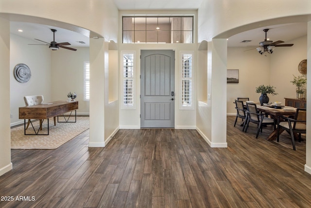 654 E County Down Dr, Chandler, AZ 85249 - foyer entrance featuring ceiling fan, arched walkways, dark wood-style flooring, and a high ceiling