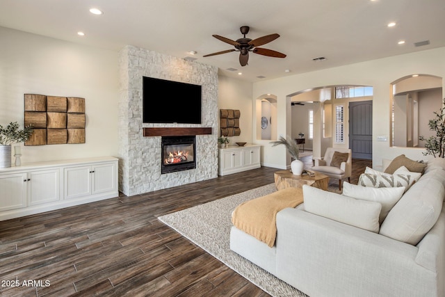 654 E County Down Dr, Chandler, AZ 85249 - living room with ceiling fan, arched walkways, recessed lighting, dark wood-style flooring, and a fireplace