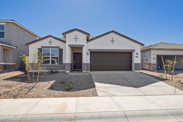 17778 W Turquoise Ave, Waddell, AZ 85355 - view of front of home featuring an attached garage, stucco siding, and driveway