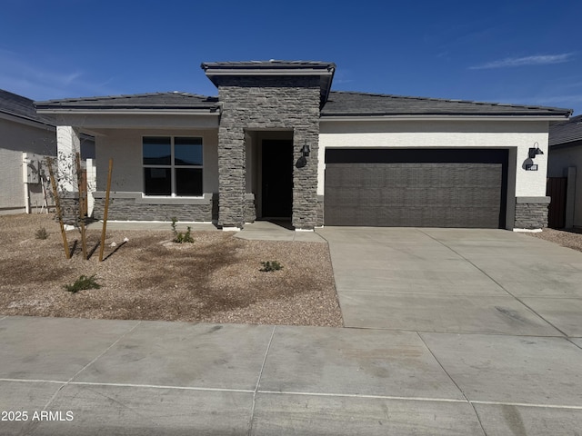 17778 W Turquoise Ave, Waddell, AZ 85355 - prairie-style home featuring stone siding, an attached garage, driveway, and stucco siding