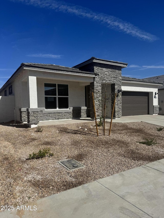 17778 W Turquoise Ave, Waddell, AZ 85355 - prairie-style house with stone siding, a garage, stucco siding, and concrete driveway
