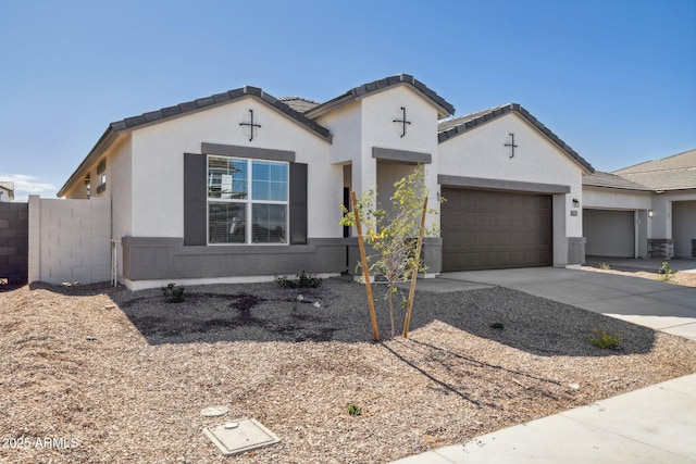 17778 W Turquoise Ave, Waddell, AZ 85355 - view of front of property with an attached garage, concrete driveway, and stucco siding