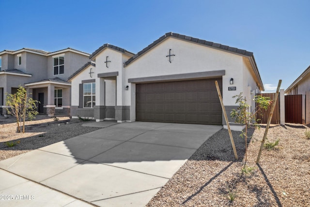 17778 W Turquoise Ave, Waddell, AZ 85355 - view of front of house featuring an attached garage, stucco siding, and driveway
