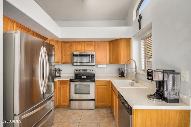 kitchen with light tile patterned floors, sink, and appliances with stainless steel finishes