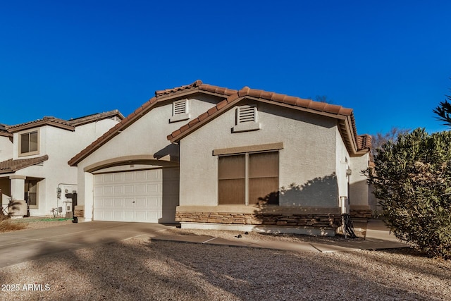 mediterranean / spanish home featuring a garage